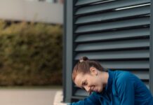 규칙적인 운동의 중요성 a woman sitting on the ground with her foot on a cup