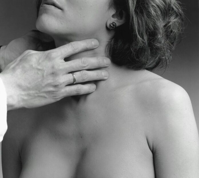 Photo by National Cancer Institute a woman has her hand on the shoulder of a man