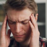 “지치고 무기력한 당신, 만성피로 벗어나기 위한 생활 속 작은 변화” a man holding his hands to his ears