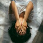 스트레스, 일상 속 작은 변화로 다스린다…실천 가능한 관리법 주목 a woman holds her hands over her face