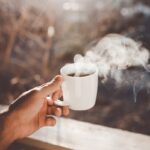 아침을 여는 힘, ‘모닝 루틴’이 바꾸는 건강한 하루 person holding white ceramic cup with hot coffee